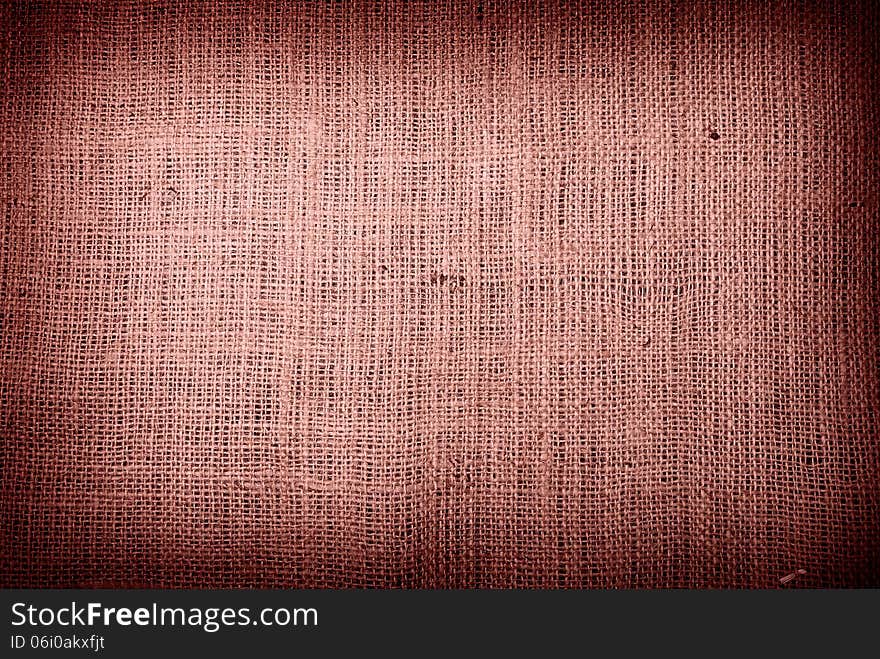 Fragment of rough brown textile background. Fragment of rough brown textile background