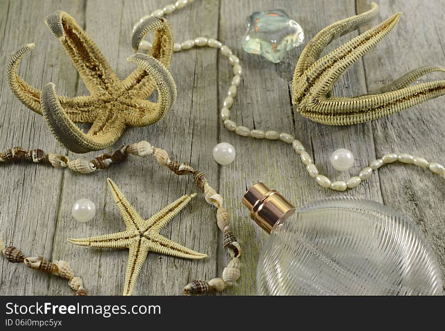 Marine still life with starfish, perfume bottles and sea objects on wood. Marine still life with starfish, perfume bottles and sea objects on wood