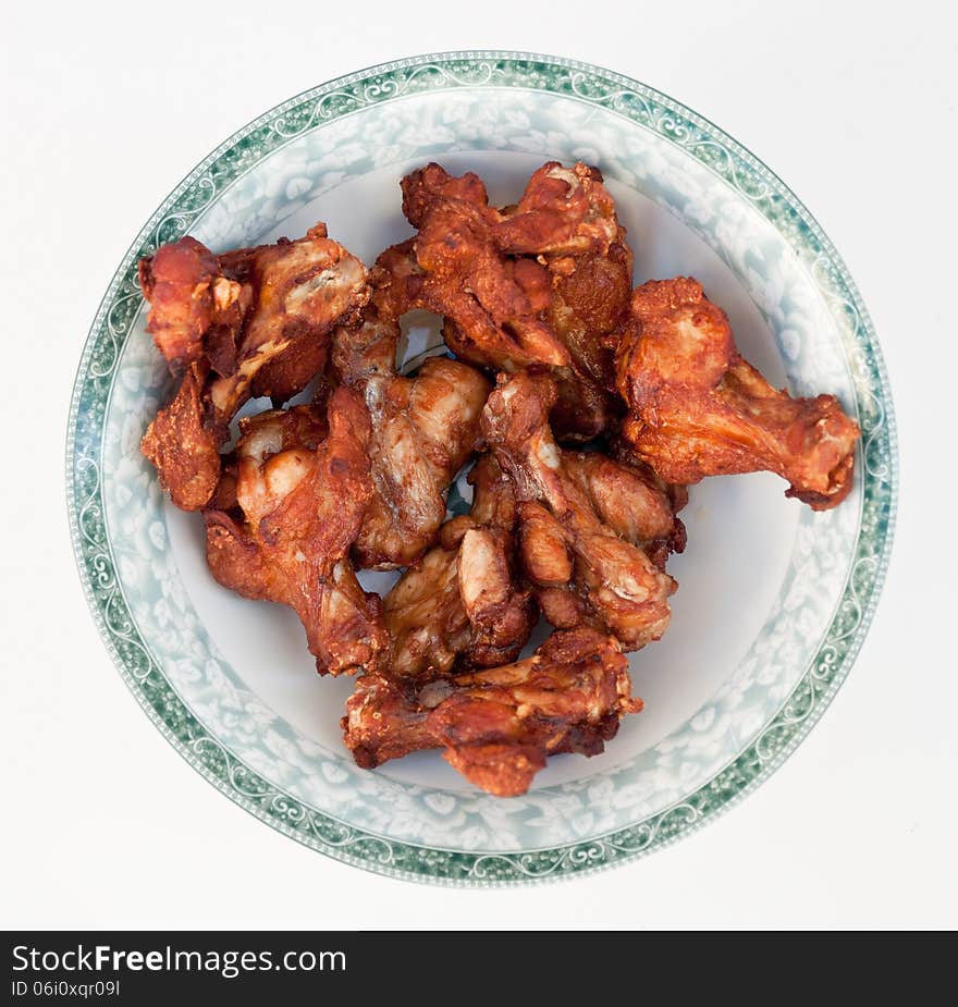 Few legs of grilled chicken in the round dish. Few legs of grilled chicken in the round dish