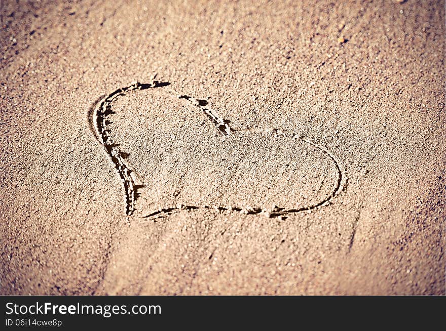 Concept of love. shape of heart drawn in the sand. Concept of love. shape of heart drawn in the sand