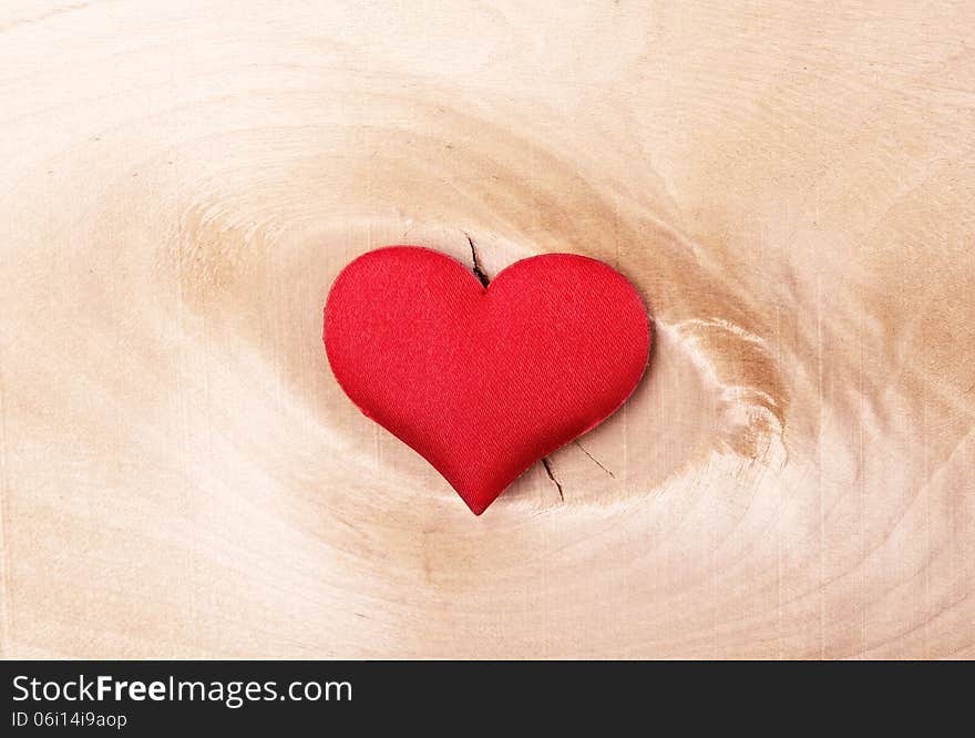 Valentine card. red heart on a light wooden background