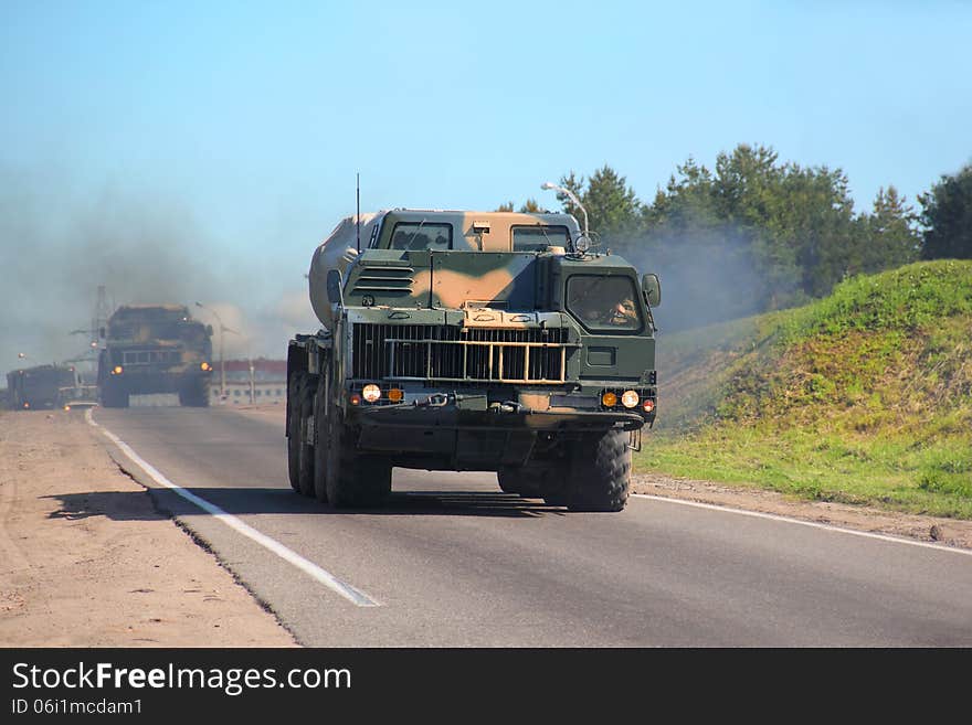 Ensuring the security of the country. Multiple rocket launchers Smerch(Tornado). Missile can hit a target at a distance of 120 kilometers. A column of military vehicles traveling along a mountain road. Ensuring the security of the country. Multiple rocket launchers Smerch(Tornado). Missile can hit a target at a distance of 120 kilometers. A column of military vehicles traveling along a mountain road.