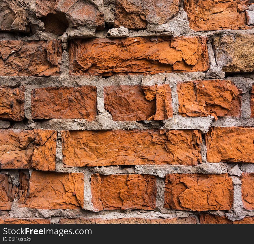 Old brick wall partially breakaway lit by sunlight. Old brick wall partially breakaway lit by sunlight