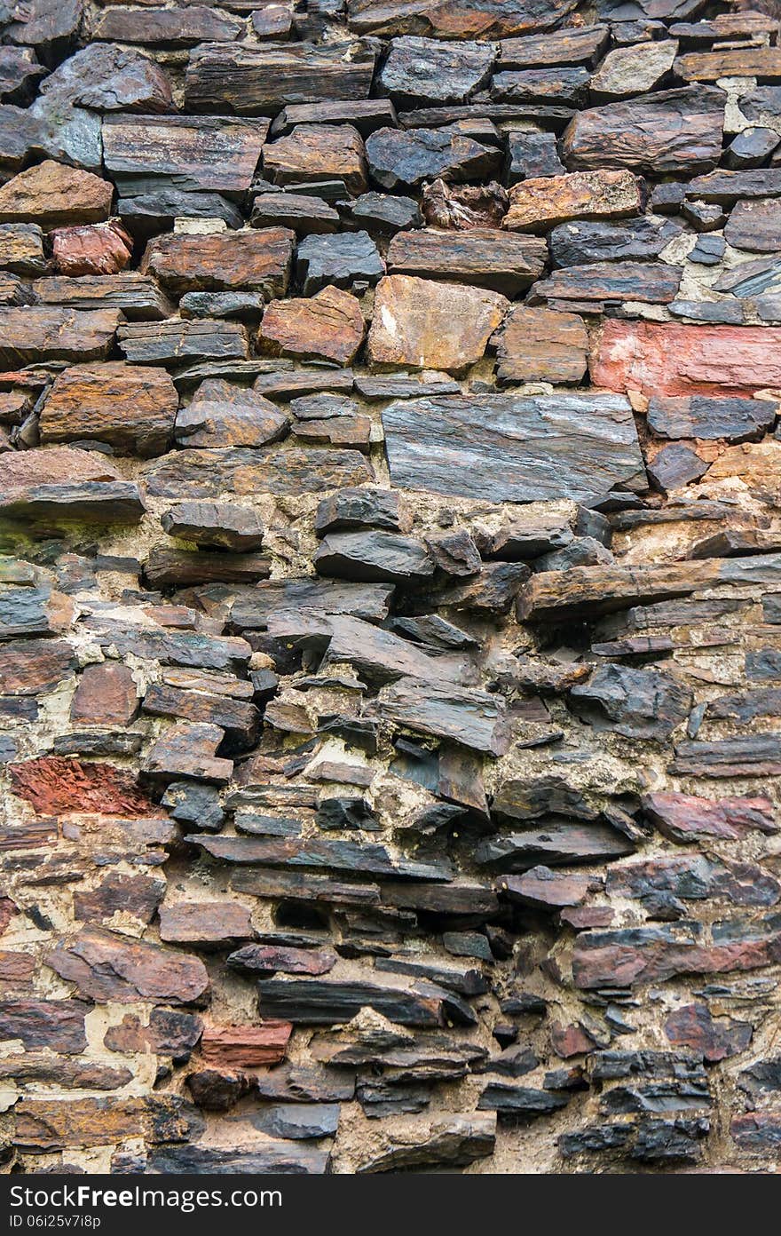 Old stone wall illuminated by sunlight