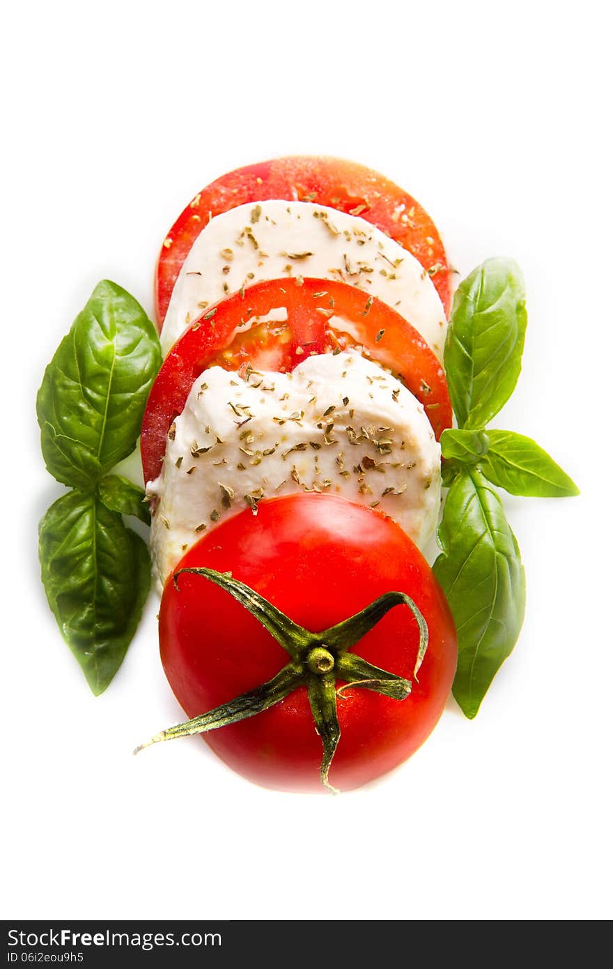 A mozzarella tomatoes basil on a white background