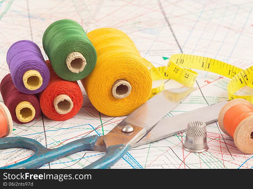 Old scissors and vintage spools of colorful thread. Old scissors and vintage spools of colorful thread