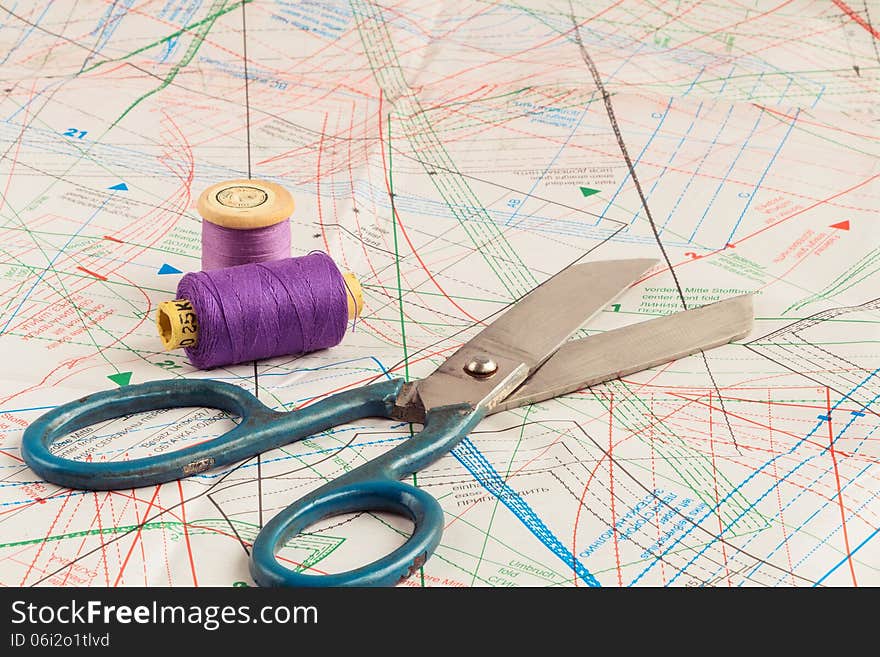 Old scissors of the tailor and purple threads