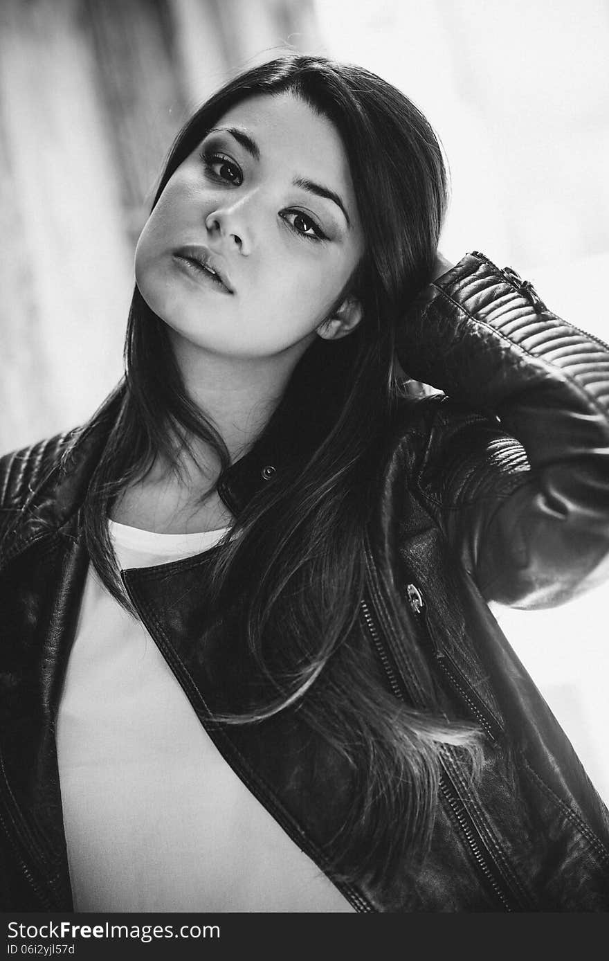 Portrait of beautiful japanese woman in urban background wearing leather jacket