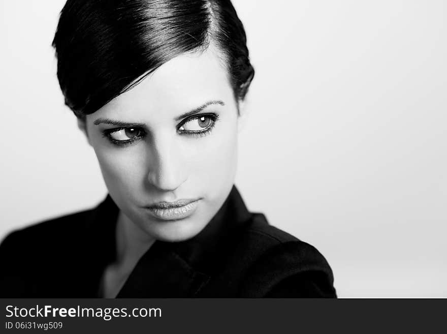 Portrait of woman with intense look on white background. Studio portrait