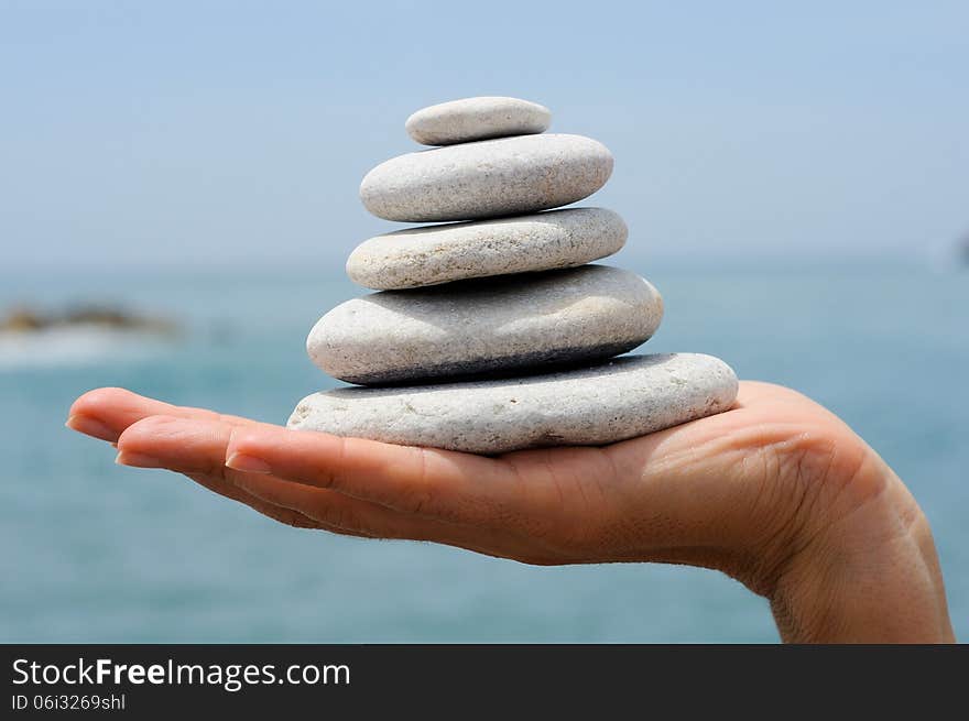 Gravel Pile In Woman S Hands With Sea Background