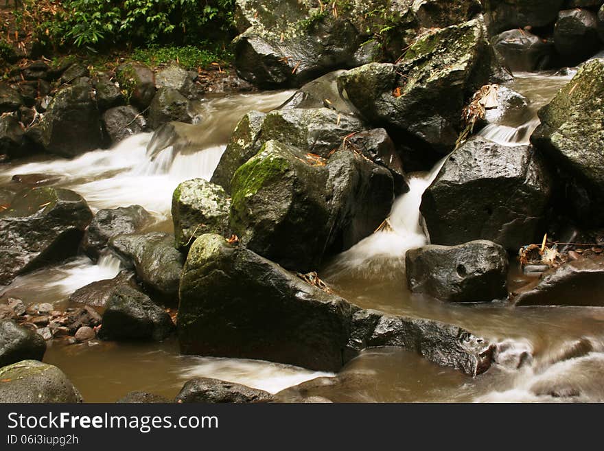 Flow of river water under the falls in Magelang, Indonesia