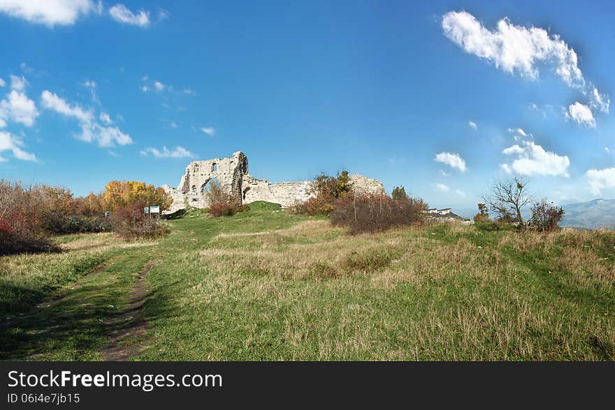 The ruins of the fortress wall, the elements of the ancient stonework of the fortress wall, panoramic view. The ruins of the fortress wall, the elements of the ancient stonework of the fortress wall, panoramic view