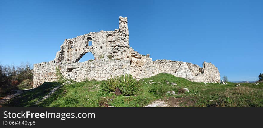 The ruins of the fortress wall, the elements of the ancient stonework of the fortress wall, panoramic view. The ruins of the fortress wall, the elements of the ancient stonework of the fortress wall, panoramic view