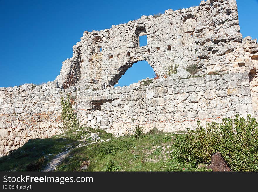 The ruins of the fortress wall, the elements of the ancient stonework of the fortress wall, panoramic view. The ruins of the fortress wall, the elements of the ancient stonework of the fortress wall, panoramic view