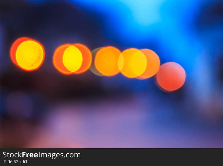 Abstract background of blurred warm lights with cool blue and purple background with bokeh effect. Abstract background of blurred warm lights with cool blue and purple background with bokeh effect