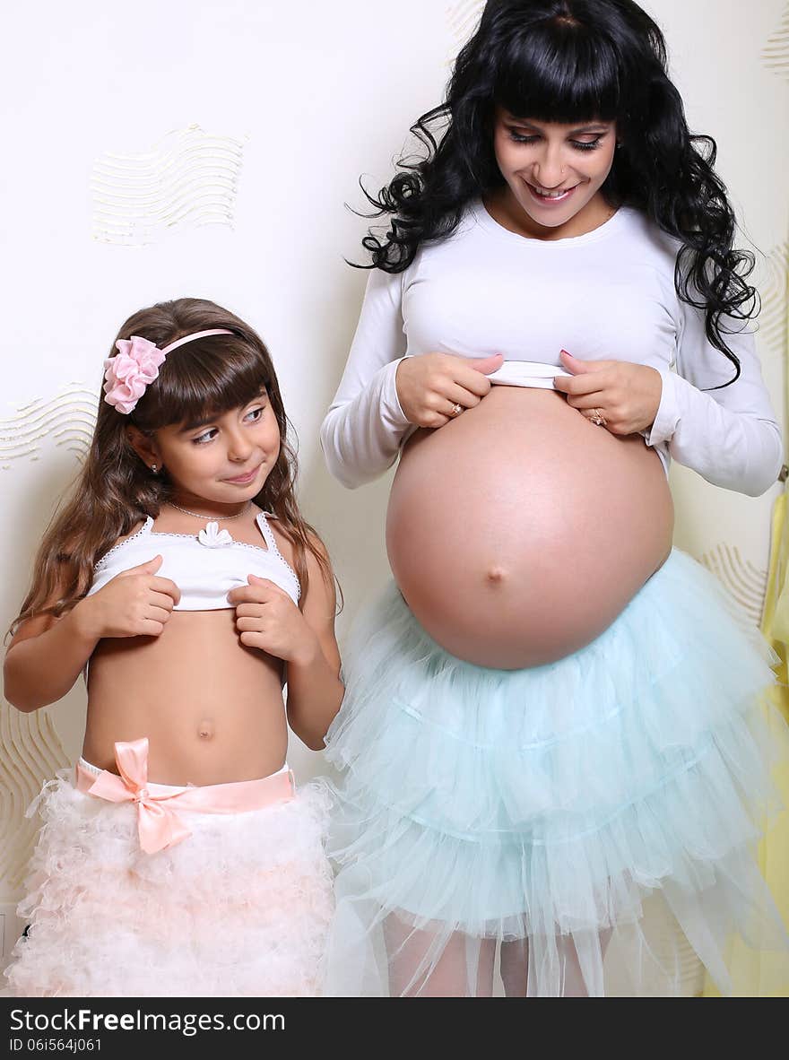 Beautiful Pregnant Woman With Her Little Funny Daughter