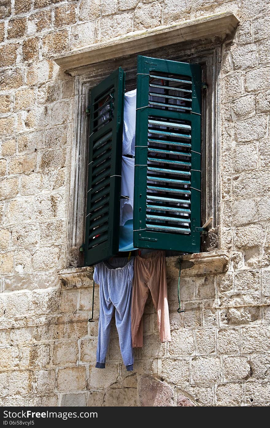 Window with shutters and linens in the Montenegrin town of Kotor.