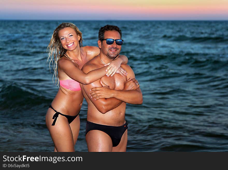 Woman pictured at sunset on the beach and in the sea. Woman pictured at sunset on the beach and in the sea.