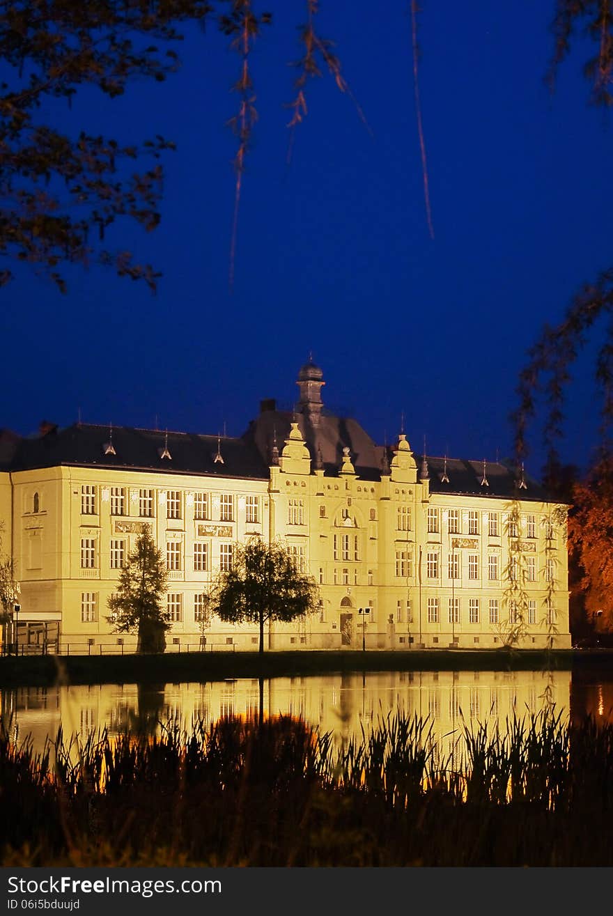 The historic high school building built in 1901, in the reflection surface of a pond, Litovel, Czech Republic. The historic high school building built in 1901, in the reflection surface of a pond, Litovel, Czech Republic.