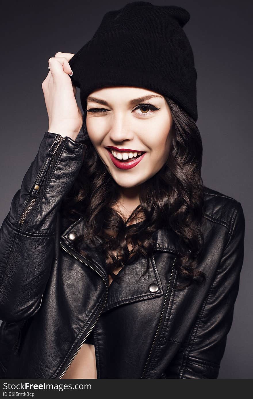 Beautiful girl with black hair in black hat and leather jacket. Beautiful girl with black hair in black hat and leather jacket