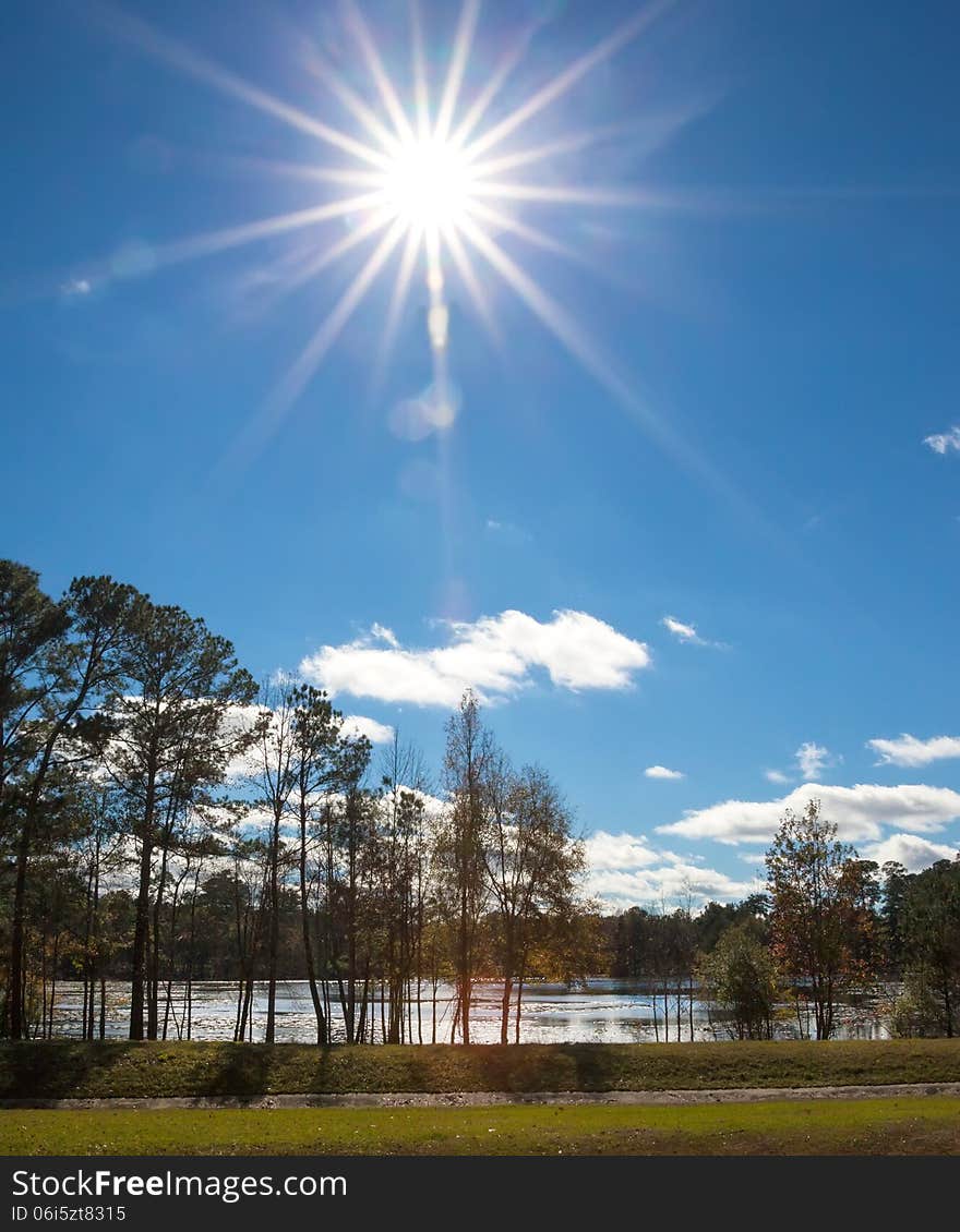 Large sunburst in sky over lake. Large sunburst in sky over lake