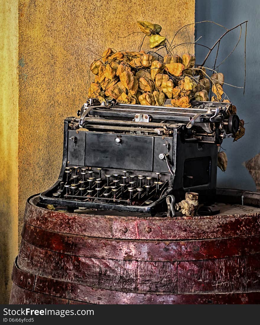 Old typewriter on a red barrel. still life