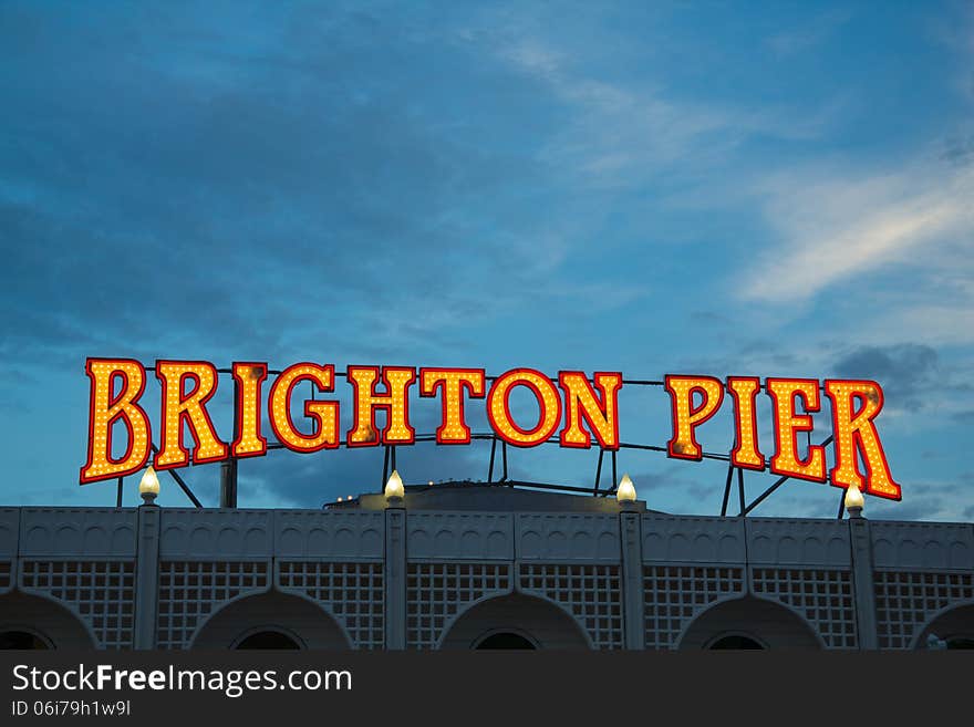 Illuminated Brighton Pier sign at the entrance to the pier, taken in the evening. Illuminated Brighton Pier sign at the entrance to the pier, taken in the evening.