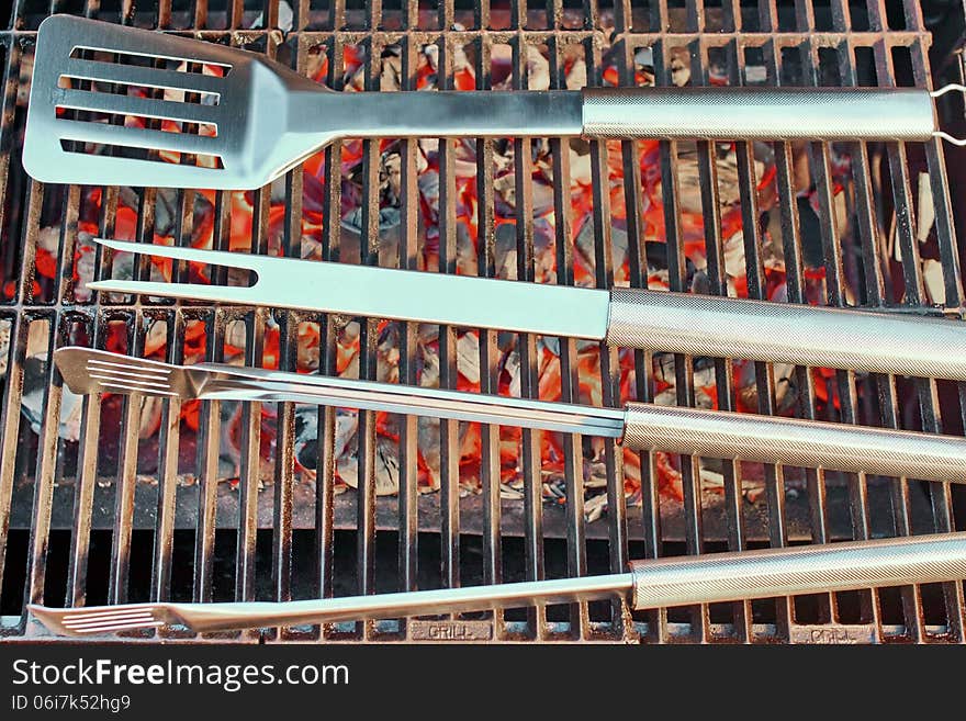 Burning charcoal in BBQ facilities and utensils on a hot grill. Burning charcoal in BBQ facilities and utensils on a hot grill