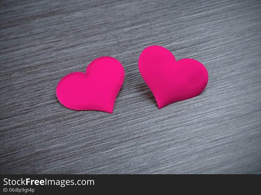 Two red hearts on a black board