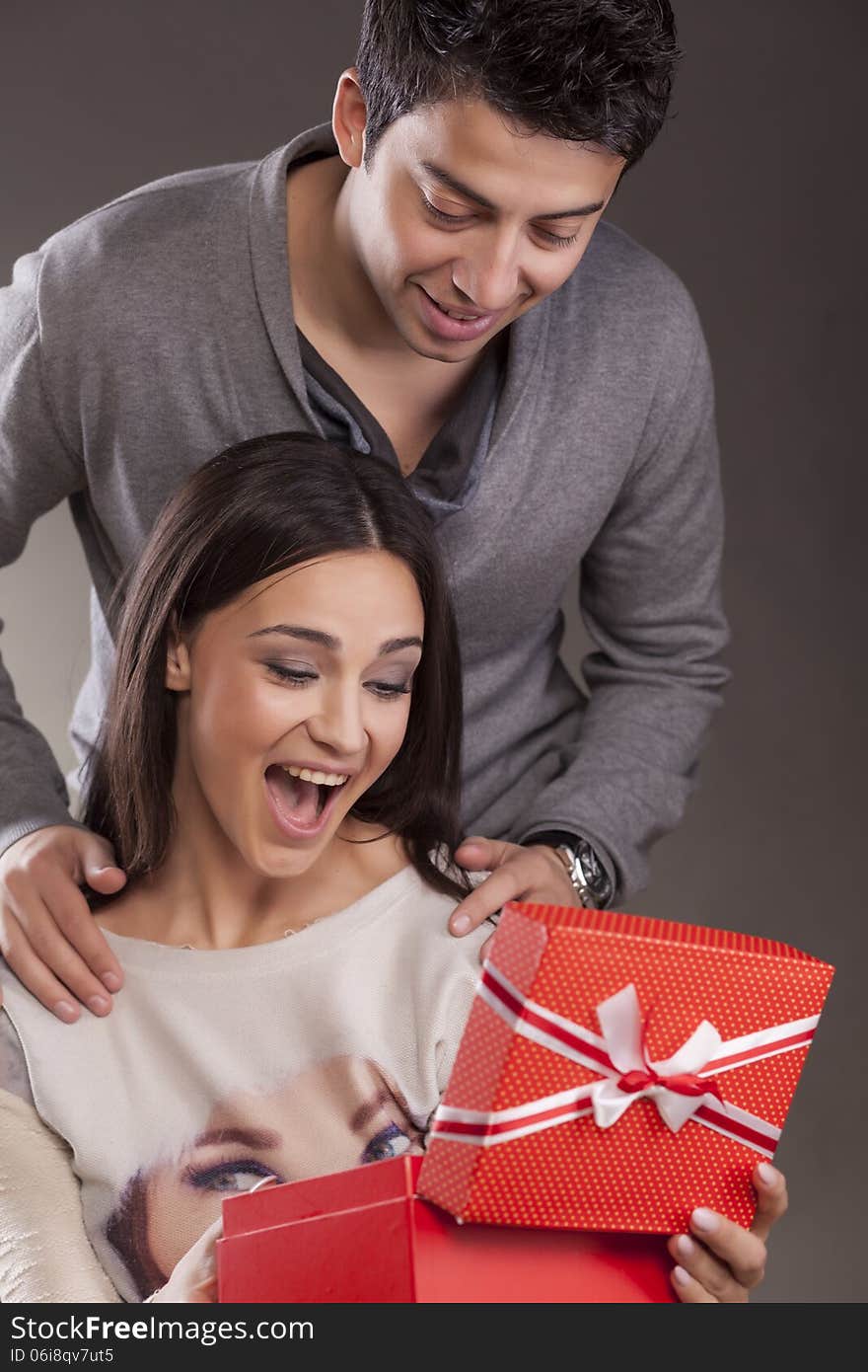 Young Man surprising women with gift for Valentine's day. Young Man surprising women with gift for Valentine's day