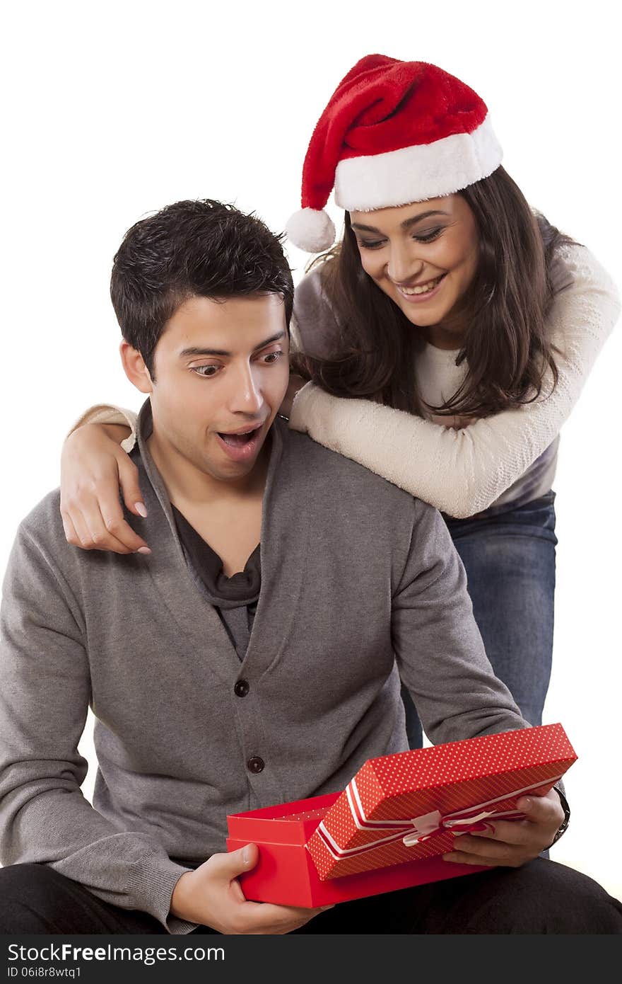 Wife surprising her husband with a christmas gift. Wife surprising her husband with a christmas gift