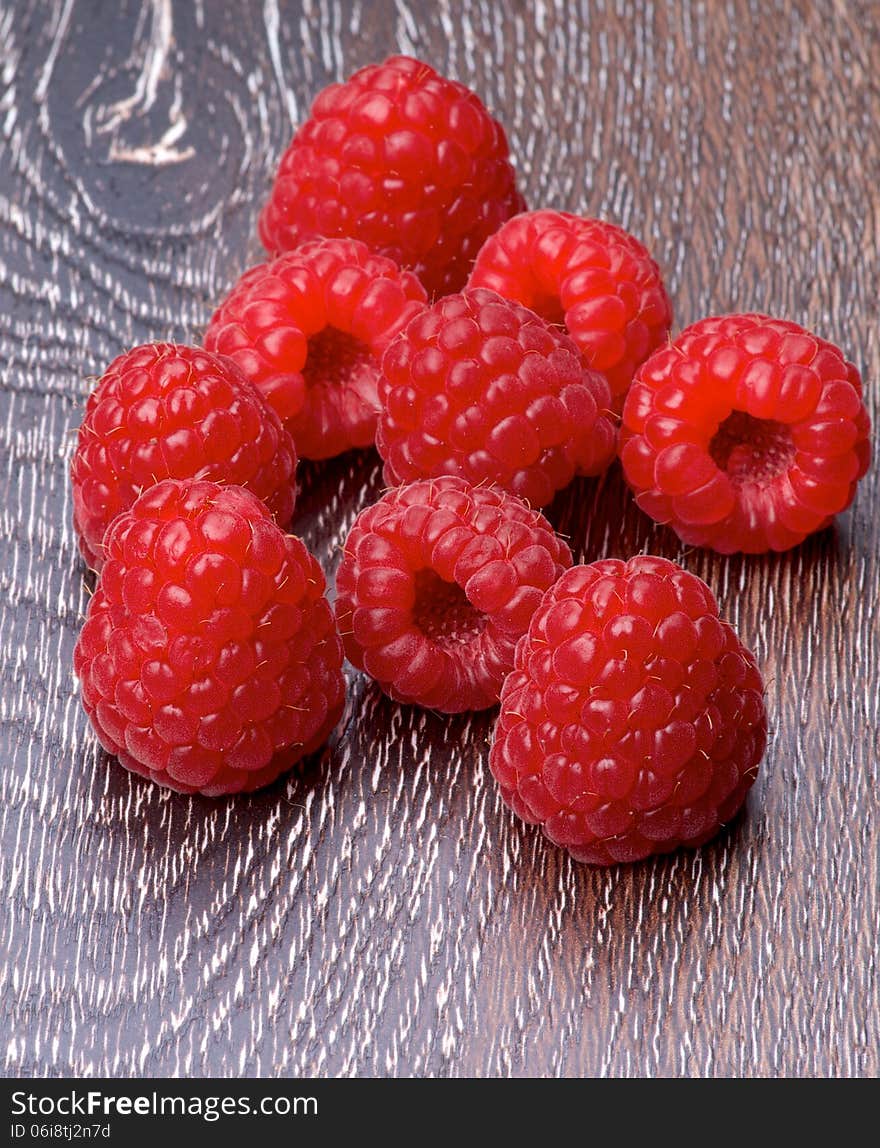 Heap of Fresh Ripe Raspberries isolated on Hardwood background