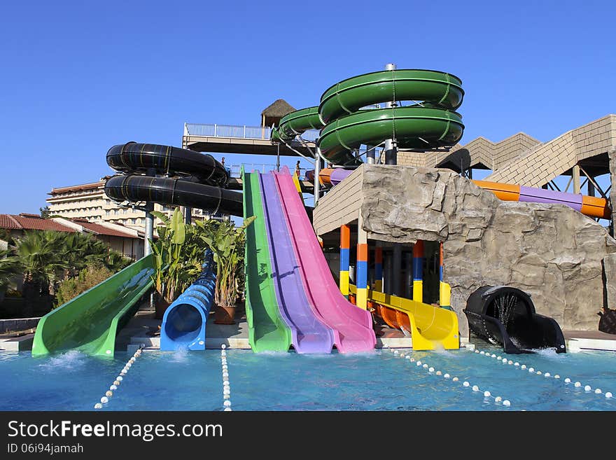 Colorful waterpark tubes and pool in Aquapark. Colorful waterpark tubes and pool in Aquapark