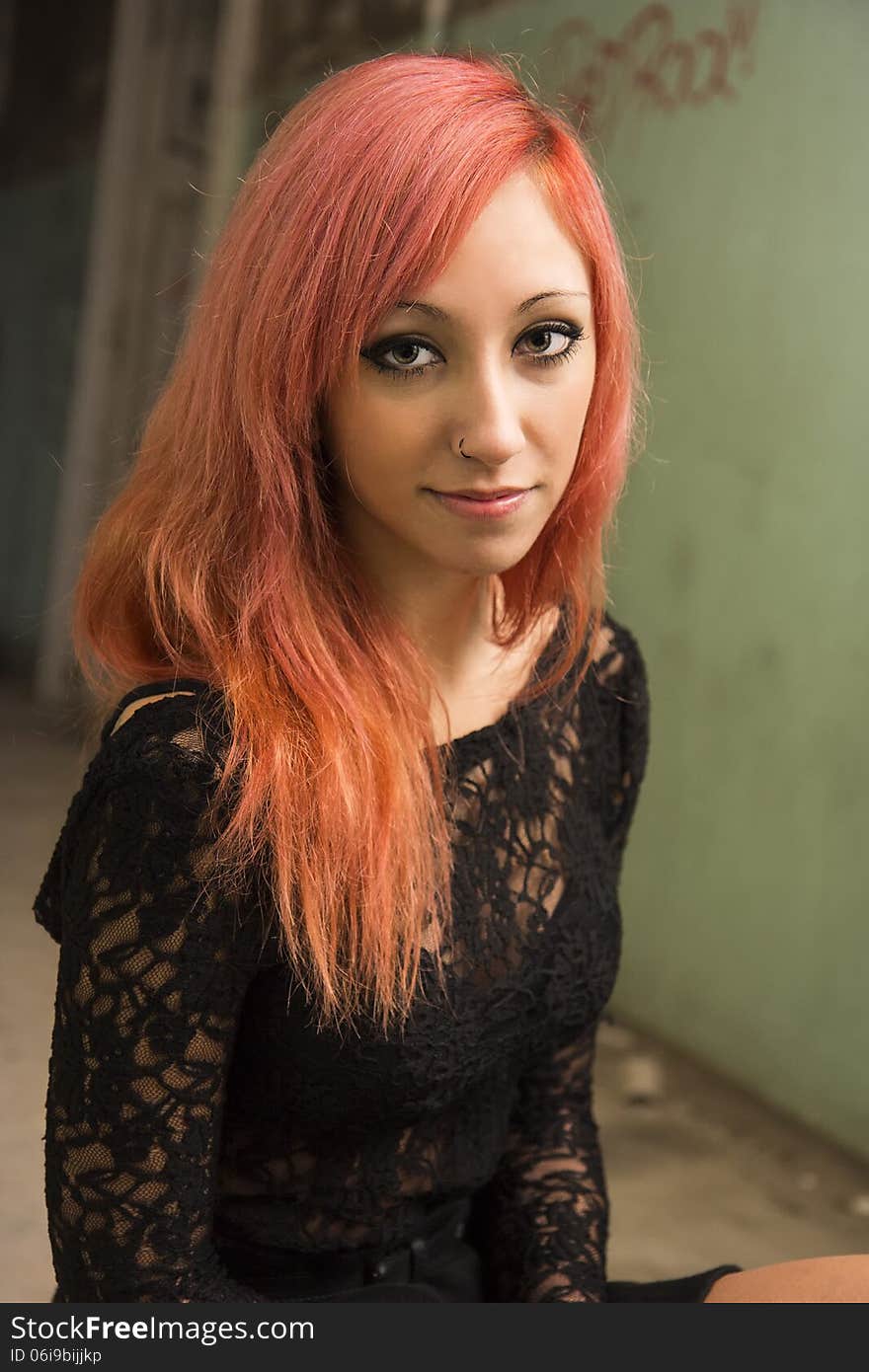 Beautiful young red haired model posing in abandoned buildings. Beautiful young red haired model posing in abandoned buildings