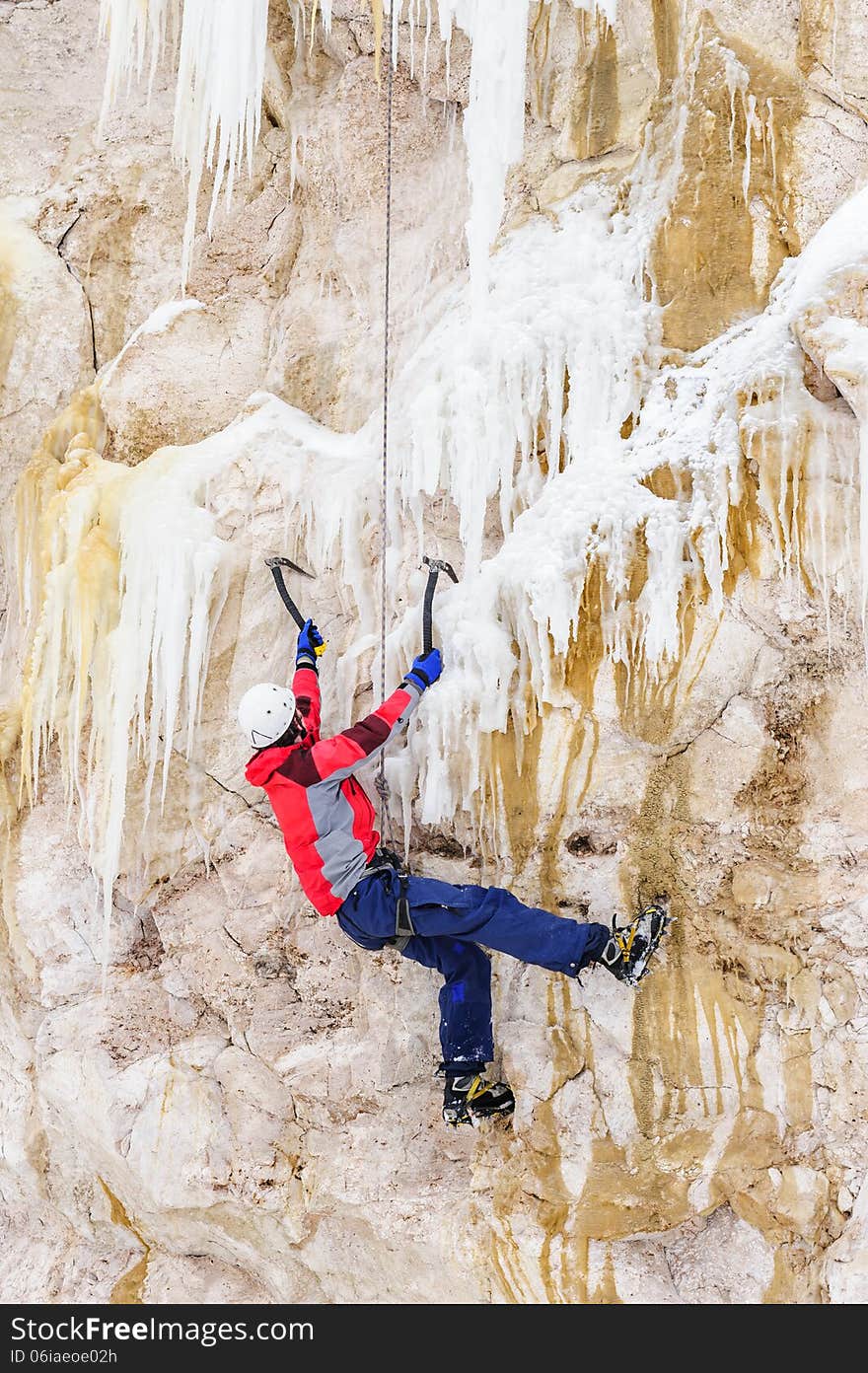 Young man climbing the ice