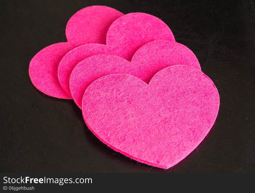 A Row From Pink Hearts Against A Dark Background