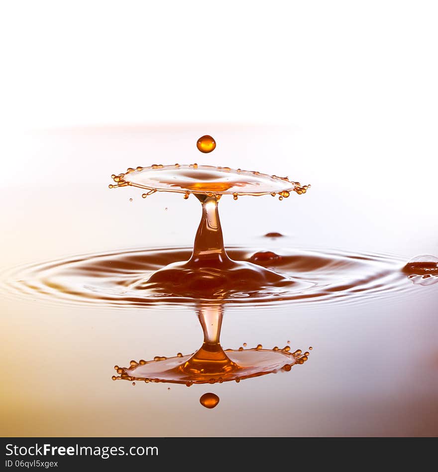 Splashing water drops on color background.Color waterdrops collide each other. Splashing water drops on color background.Color waterdrops collide each other.