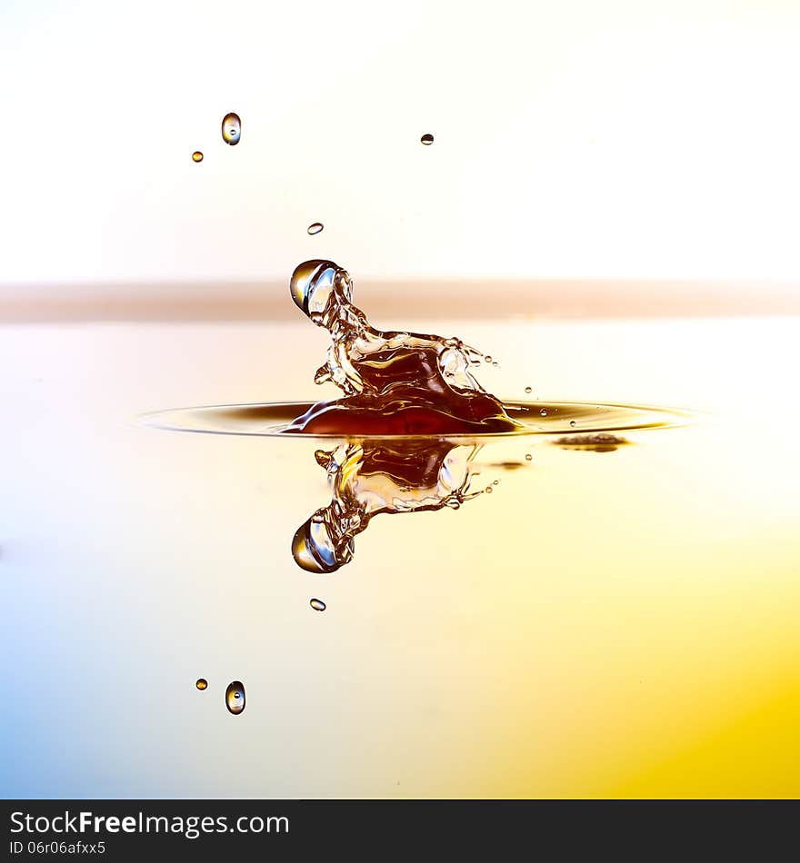 Splashing water drops on color background.Color waterdrops collide each other.