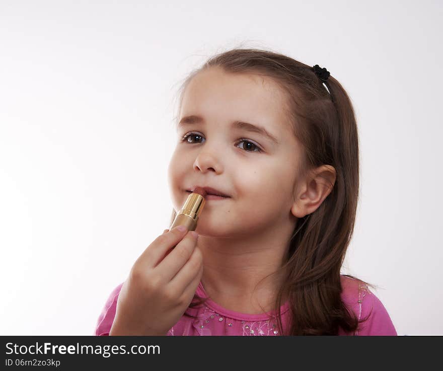 Cheerful girl paints lips