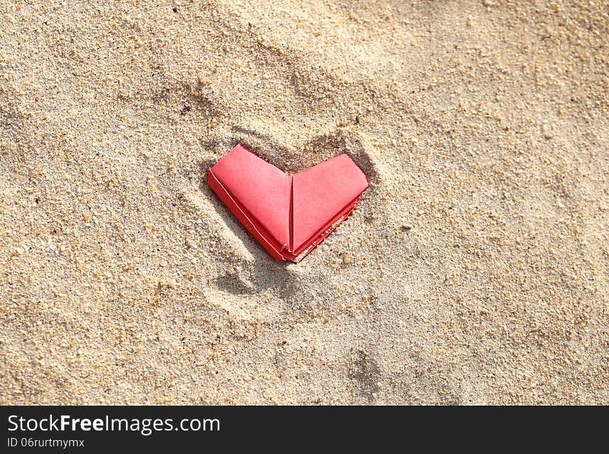 Festive pink paper heart on the beach. Festive pink paper heart on the beach