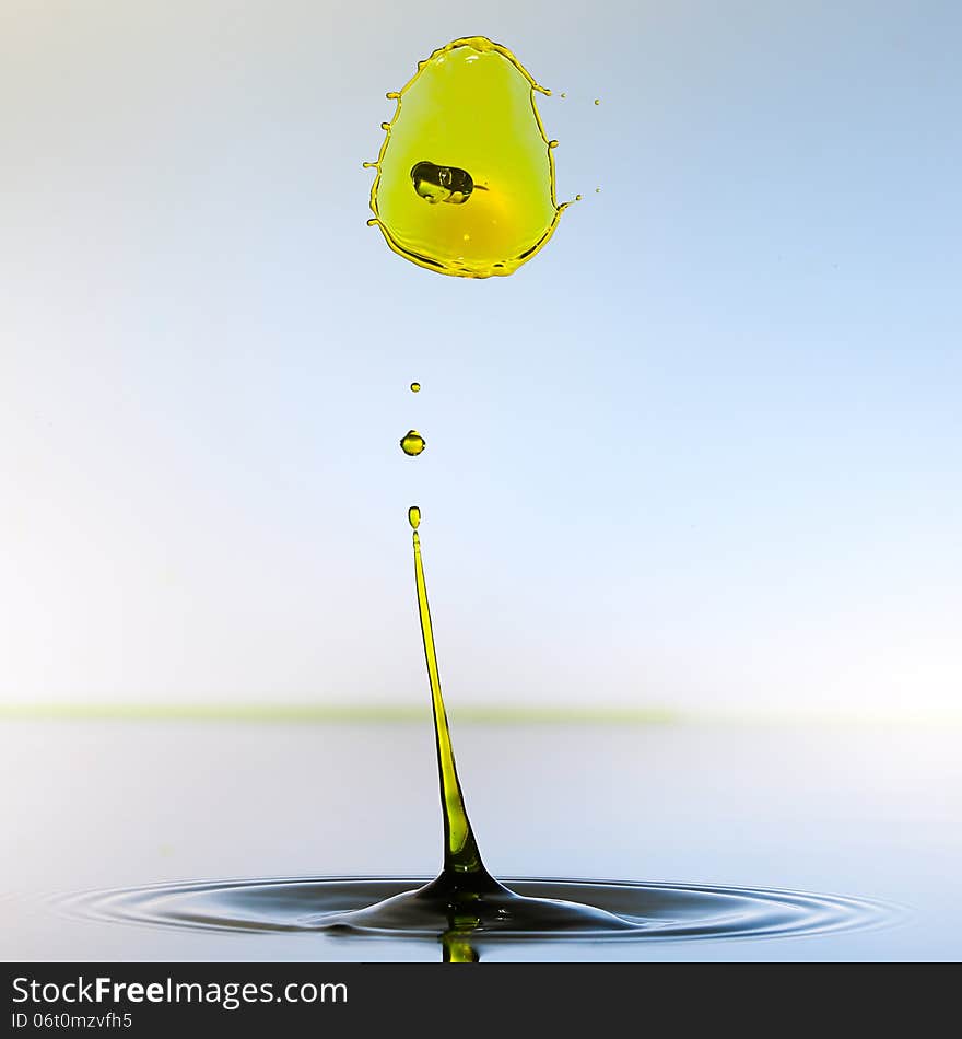 Splashing water drops on color background.Color waterdrops collide each other.