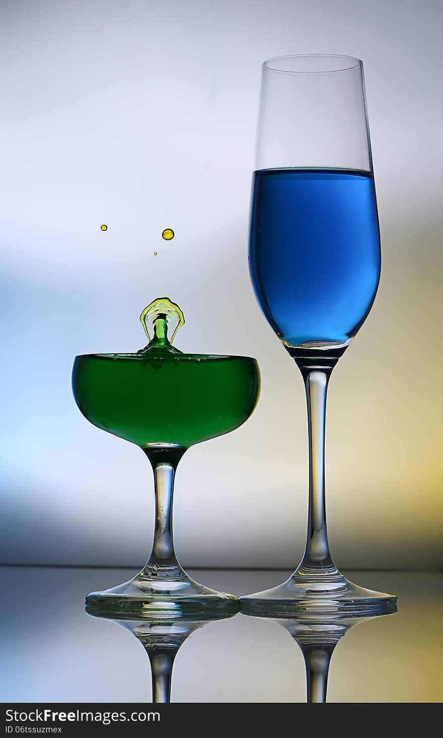 Splashing water drop on red wine glass.