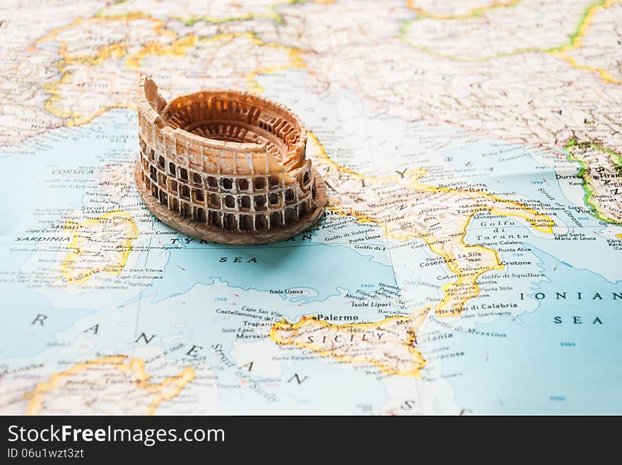 A Colosseum miniature on a map of Europe