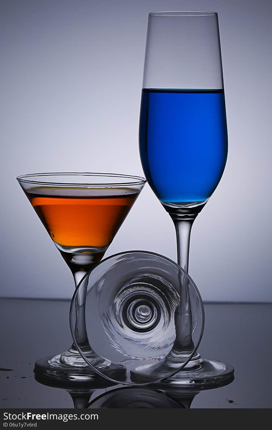 Three Glasses On Gray Background.