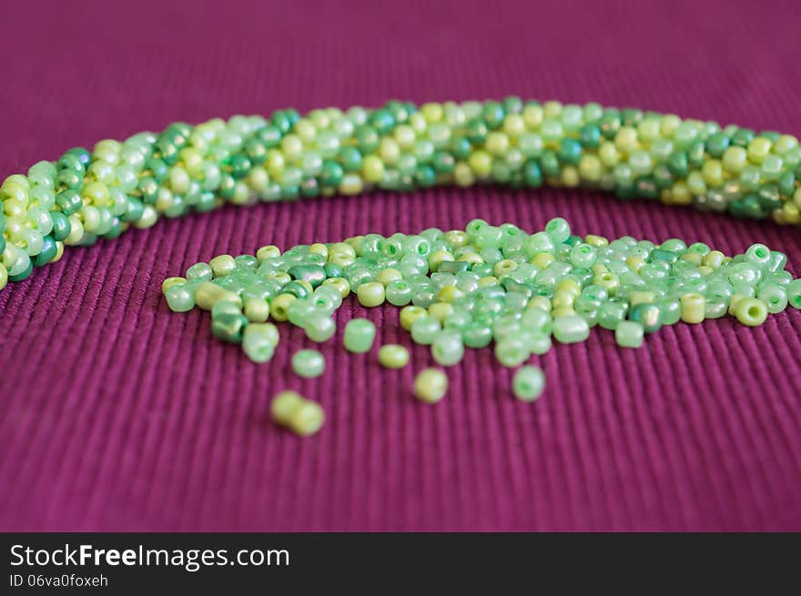 Knitted necklace and the scattered beads close up