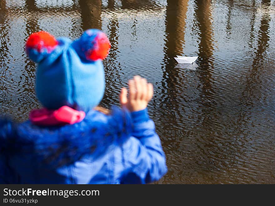 Girl Waving A Paper Boat Floating In The Creek