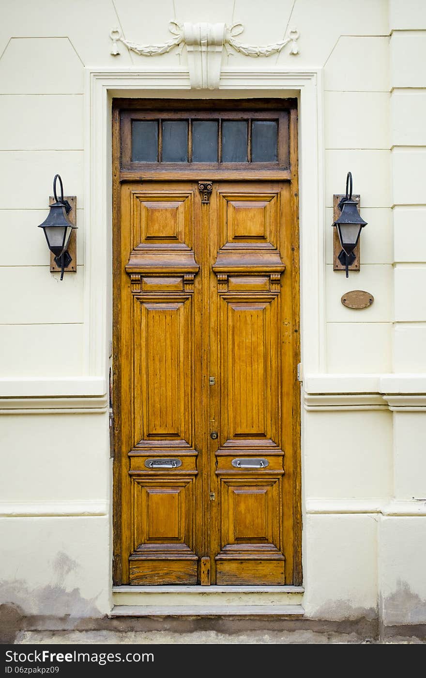 Elegant Wooden Door with Classic Lanterns and Architectural Details