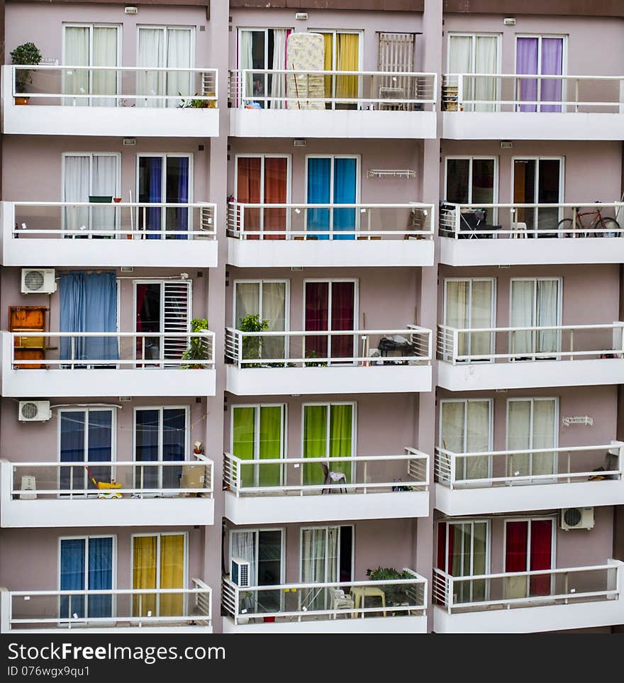 Modern Apartment Building with Colorful Balcony Curtains and Railings