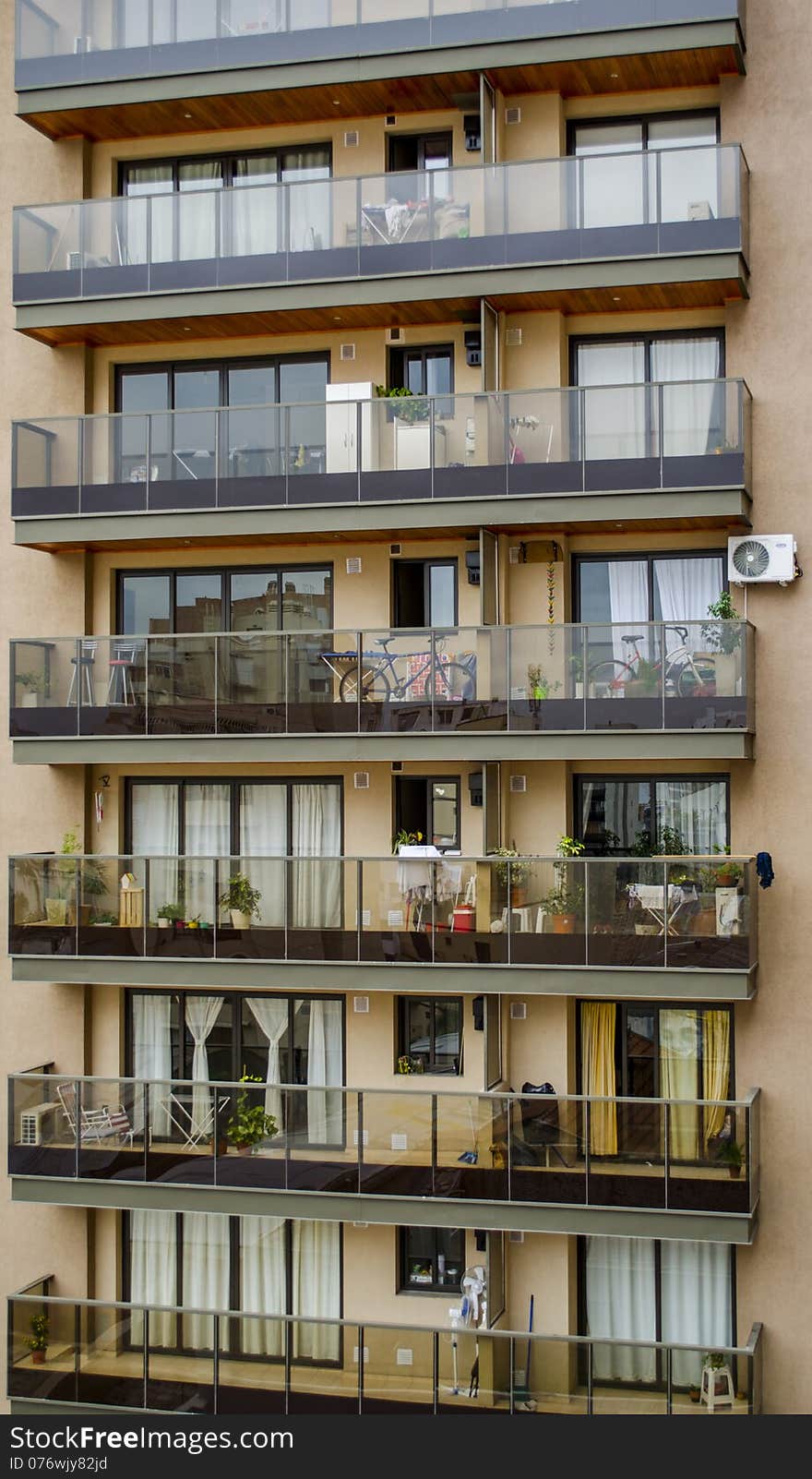 Modern Apartment Building with Glass Balconies and Personal Decorations