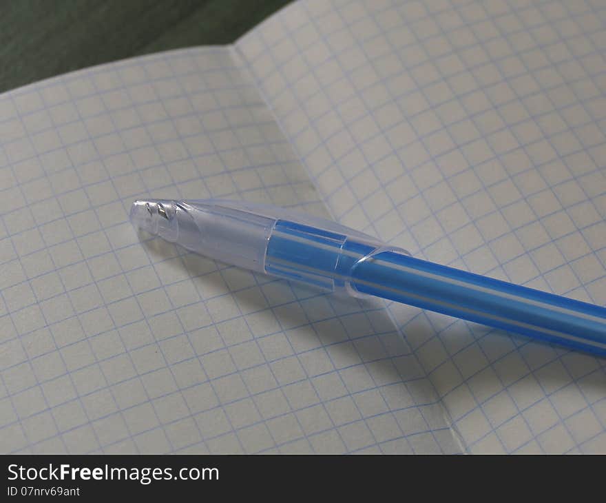 Back to school concept. Turn the notebook into a line with two pencils on the table